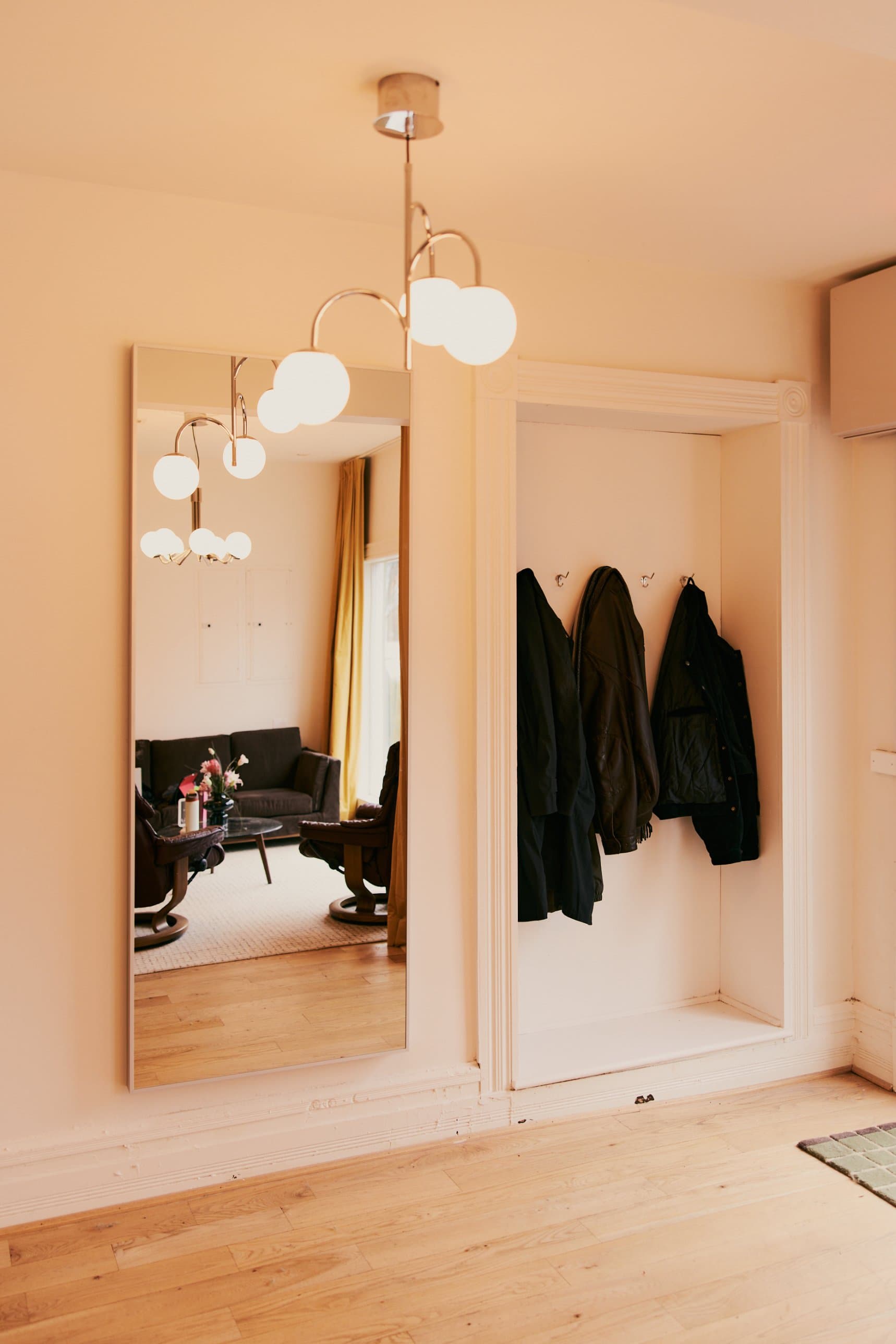 The entry, with a mirror and a coat nook