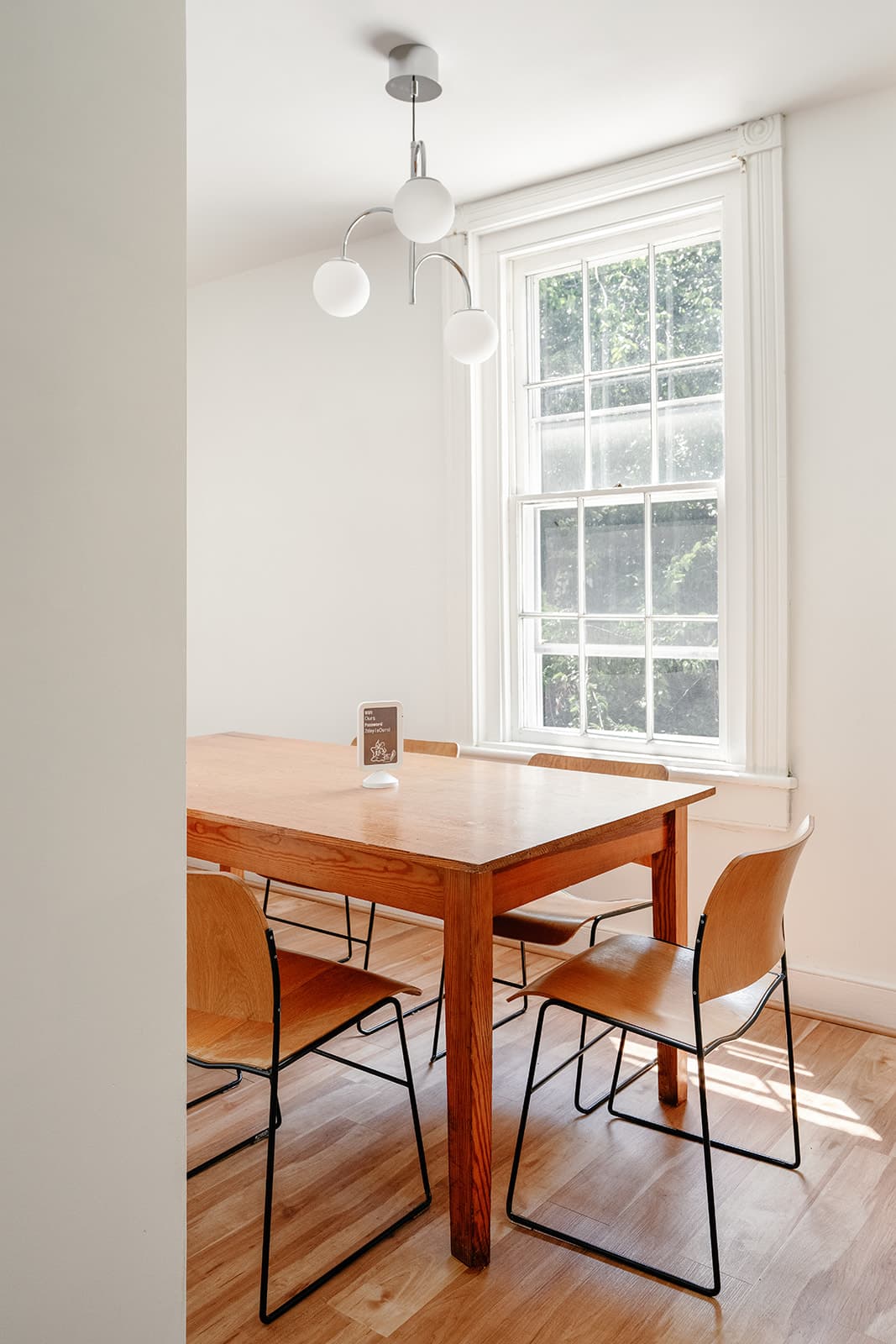 The upstairs meeting room, a wooden table under a window