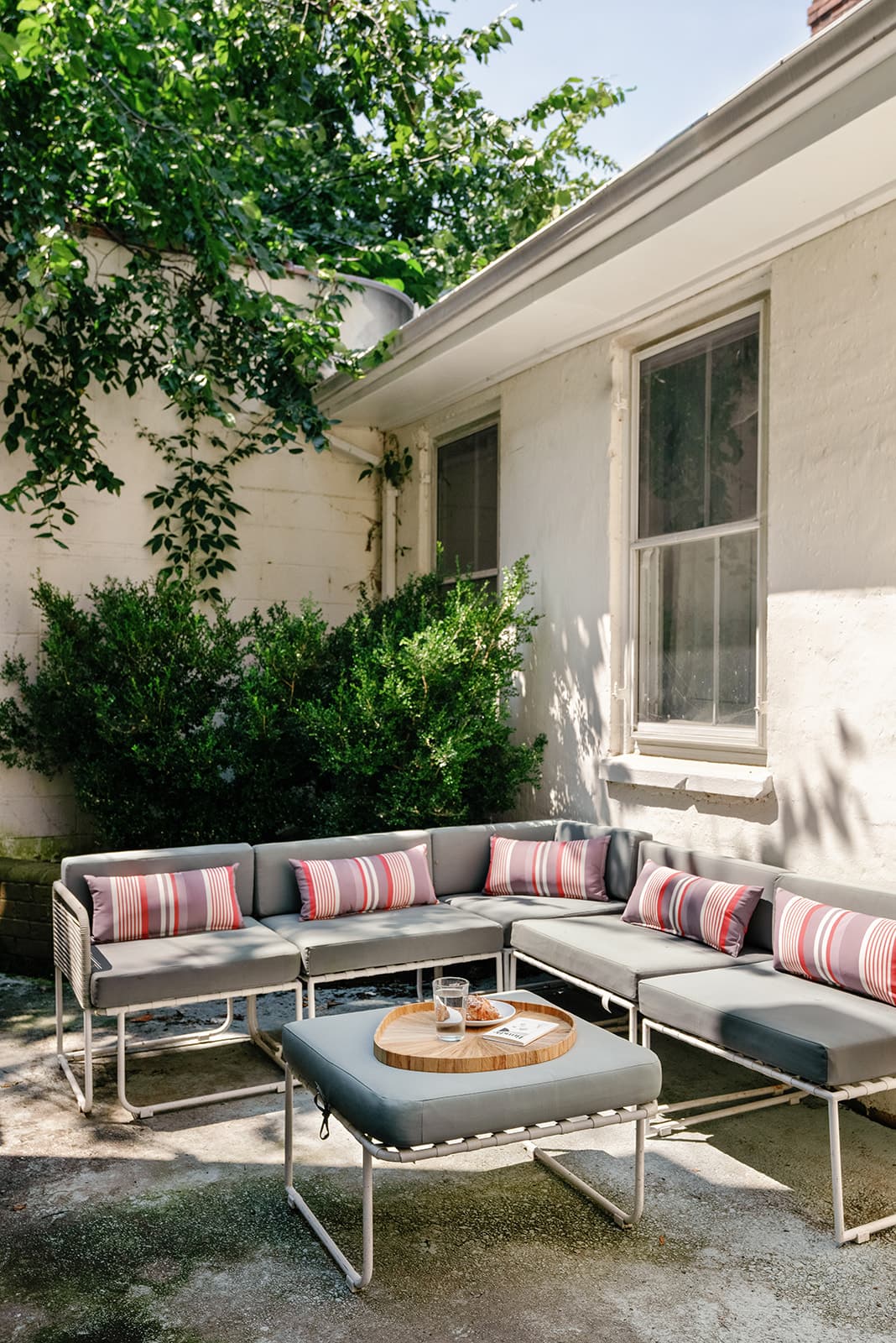 The side patio, with outdoor couches under the trees